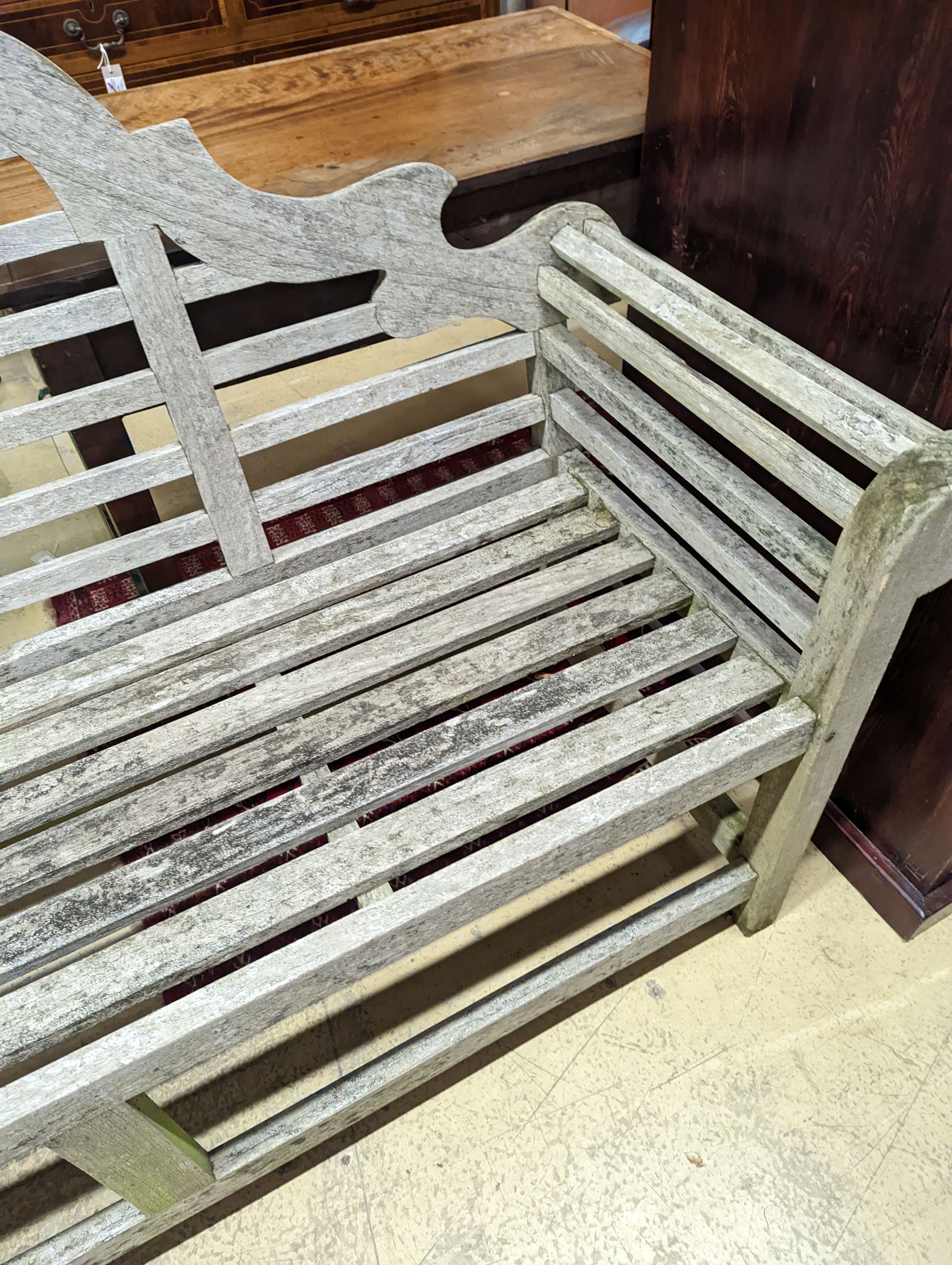 A Lutyens style weathered teak garden bench, length 166cm, depth 52cm, height 104cm